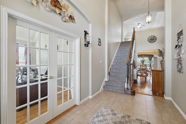 1231 Mcclintock Dr, Shady Shores, TX 76208 - entryway with arched walkways, tile patterned flooring, baseboards, stairs, and french doors