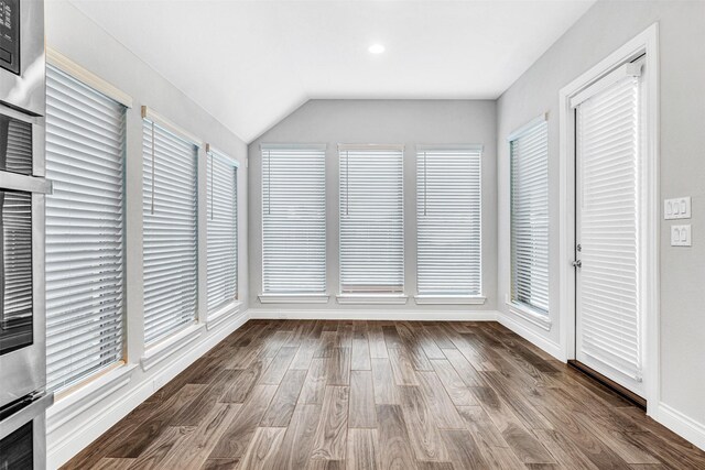 unfurnished sunroom featuring vaulted ceiling