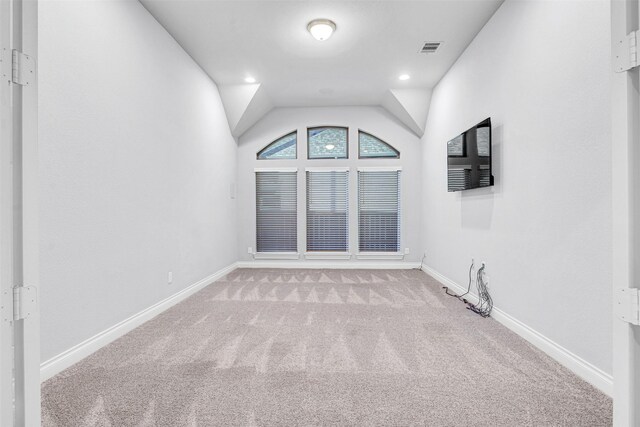 unfurnished room featuring visible vents, baseboards, lofted ceiling, carpet flooring, and recessed lighting