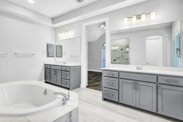 full bath featuring visible vents, a garden tub, two vanities, a stall shower, and a sink