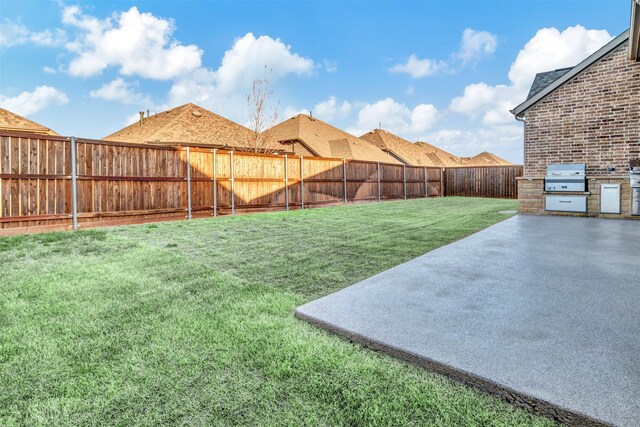 view of yard featuring area for grilling, a fenced backyard, and a patio area