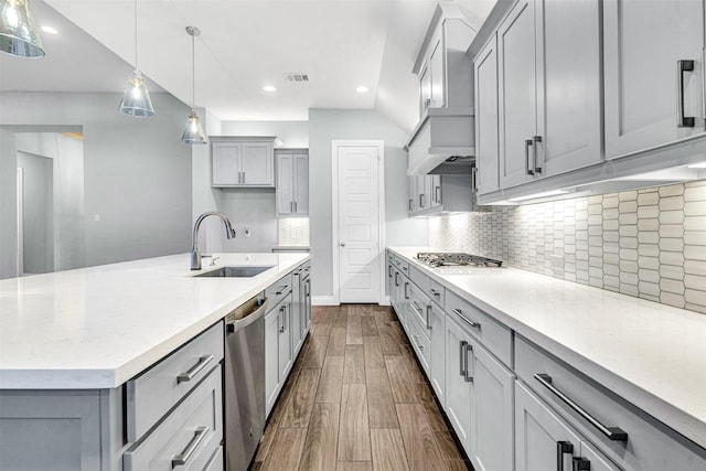 kitchen with gray cabinets, a sink, decorative light fixtures, appliances with stainless steel finishes, and wood tiled floor