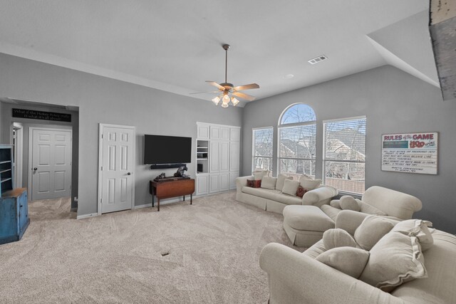 carpeted living area featuring visible vents, lofted ceiling, baseboards, and a ceiling fan