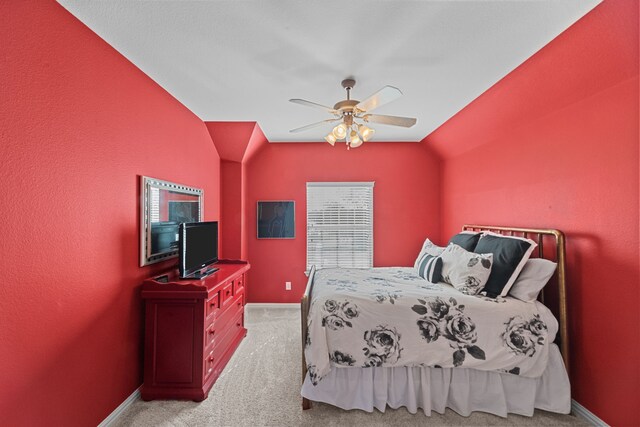 carpeted bedroom with ceiling fan, baseboards, and lofted ceiling