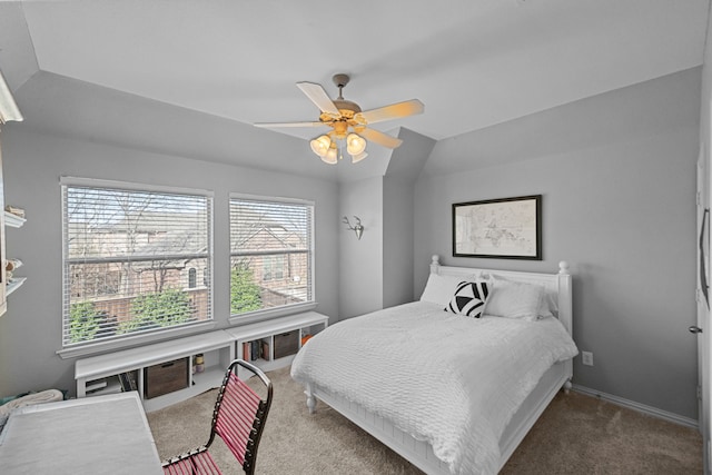 carpeted bedroom with lofted ceiling, baseboards, and ceiling fan