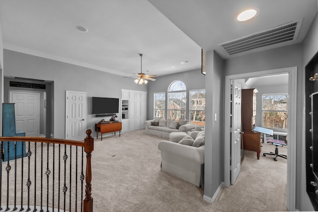 living room with visible vents, light colored carpet, plenty of natural light, and ceiling fan