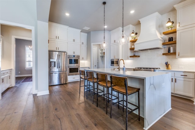 kitchen with backsplash, dark wood finished floors, custom range hood, stainless steel appliances, and open shelves