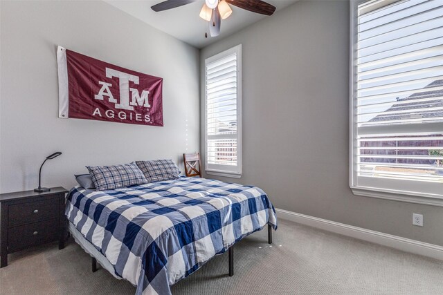 bedroom with ceiling fan, baseboards, and carpet floors