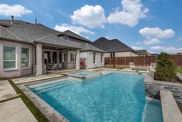 view of pool with a ceiling fan, a patio area, a fenced backyard, and a pool with connected hot tub