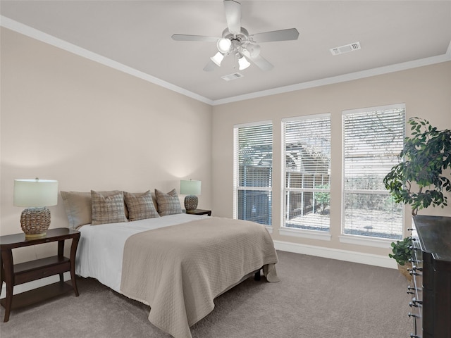 bedroom with visible vents, multiple windows, carpet, and crown molding