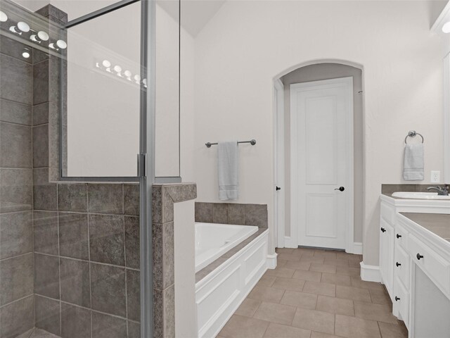 full bathroom with vanity, a shower stall, a bath, and tile patterned flooring