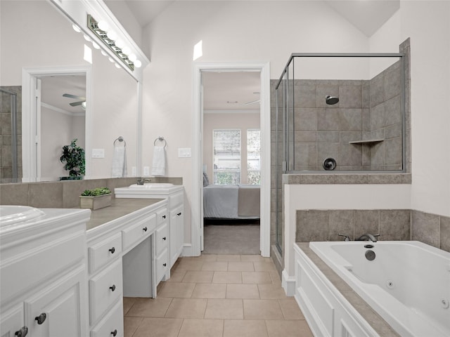 ensuite bathroom with double vanity, a shower stall, ornamental molding, and a sink