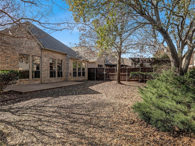 view of yard with a patio and fence