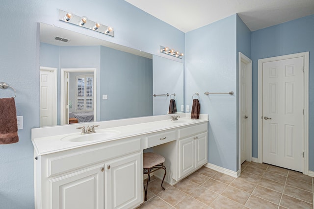 ensuite bathroom with visible vents, ensuite bathroom, a sink, tile patterned flooring, and double vanity