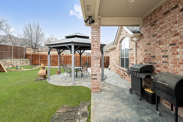 view of patio / terrace with a gazebo, area for grilling, and a fenced backyard