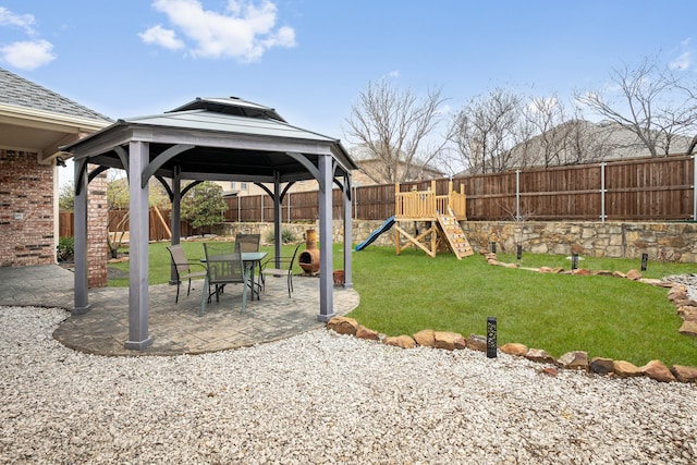 view of yard featuring a gazebo, a playground, a fenced backyard, and a patio area