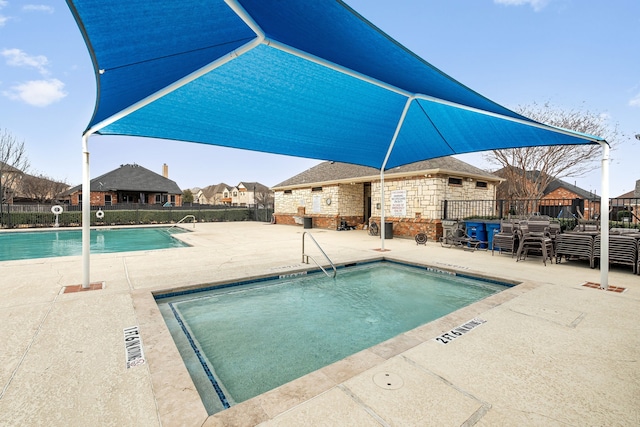 community pool featuring a patio and fence