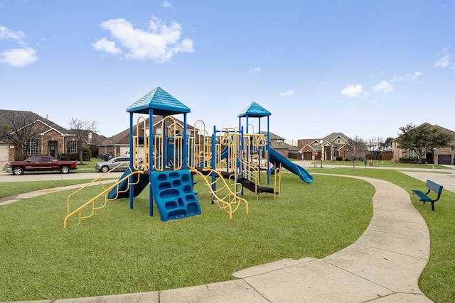 communal playground with a residential view and a lawn