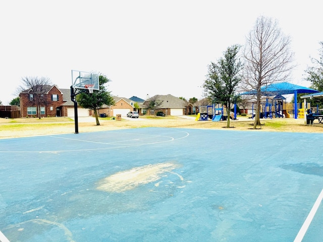 view of sport court featuring community basketball court, playground community, and a residential view