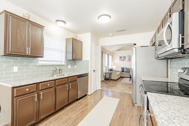 kitchen with stainless steel appliances, light wood-style floors, visible vents, and a healthy amount of sunlight