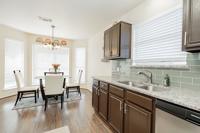 kitchen with visible vents, a sink, tasteful backsplash, dishwasher, and dark wood-style flooring