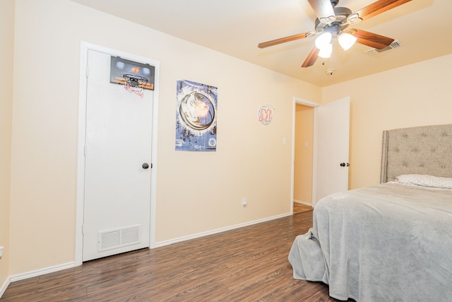 bedroom featuring visible vents, ceiling fan, baseboards, and wood finished floors