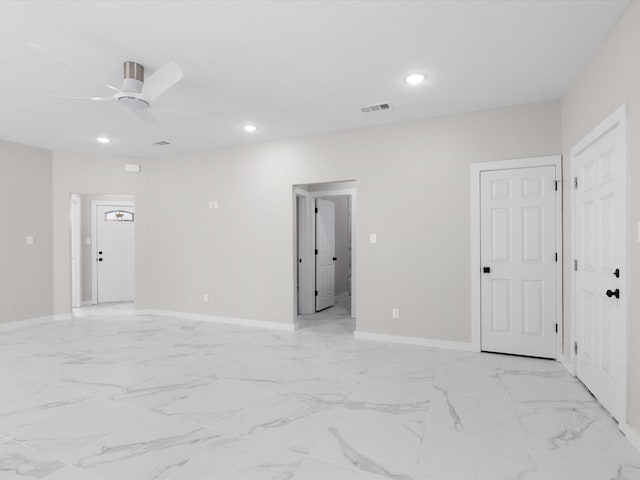 unfurnished room featuring recessed lighting, marble finish floor, visible vents, a ceiling fan, and baseboards