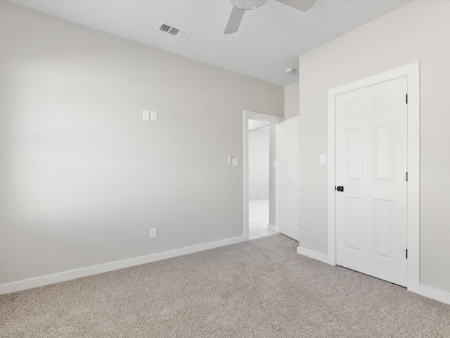 unfurnished bedroom with baseboards, visible vents, carpet, and ceiling fan