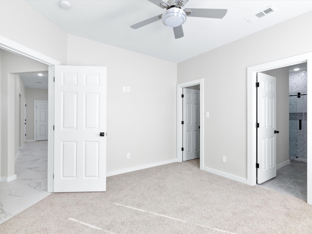 unfurnished bedroom with a ceiling fan, carpet, baseboards, ensuite bath, and visible vents