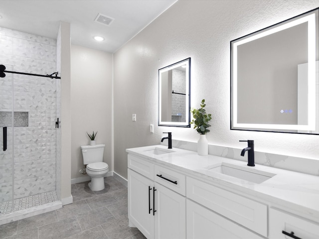 bathroom with toilet, a sink, visible vents, and a stall shower