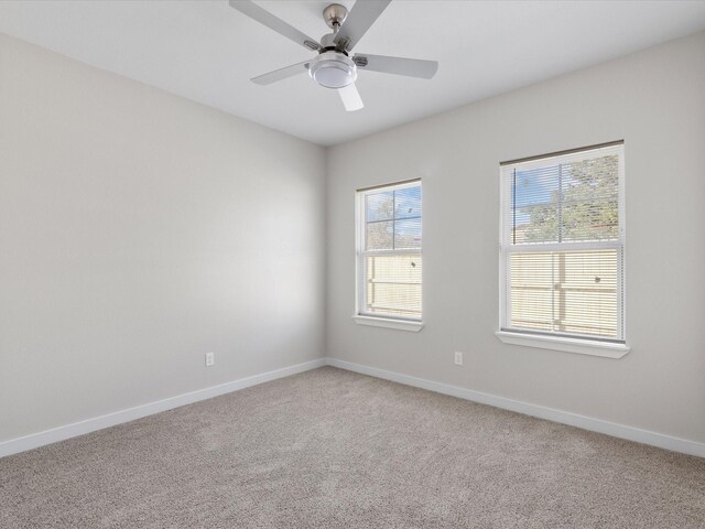 empty room with light carpet, baseboards, and ceiling fan
