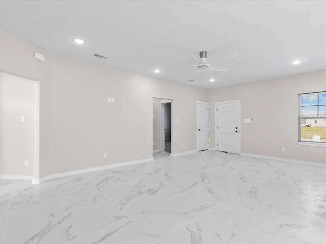 unfurnished room with marble finish floor, a ceiling fan, visible vents, and recessed lighting