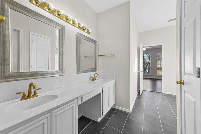 bathroom featuring double vanity, visible vents, tile patterned floors, and a sink