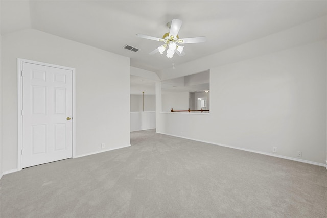 empty room featuring carpet flooring, a ceiling fan, visible vents, and baseboards