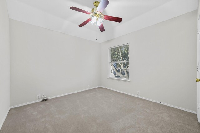 empty room with a ceiling fan, baseboards, and carpet floors