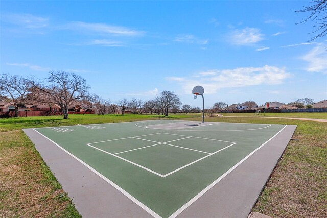 view of sport court with a lawn and community basketball court