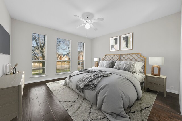 bedroom with dark wood finished floors, baseboards, and ceiling fan