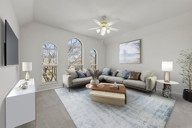 carpeted living room featuring baseboards, ceiling fan, and vaulted ceiling