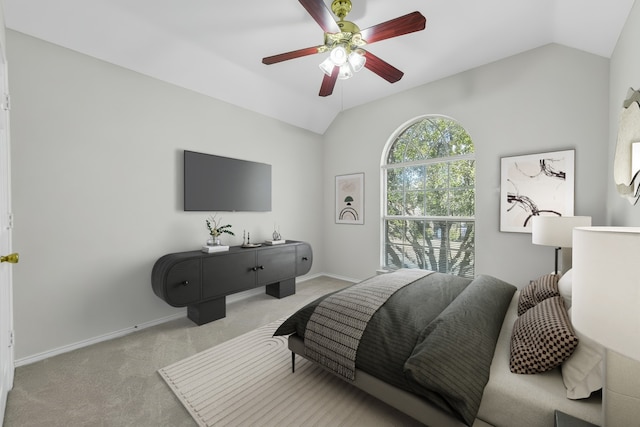 carpeted bedroom featuring vaulted ceiling, a ceiling fan, and baseboards