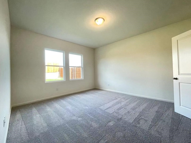 unfurnished room featuring baseboards and carpet flooring