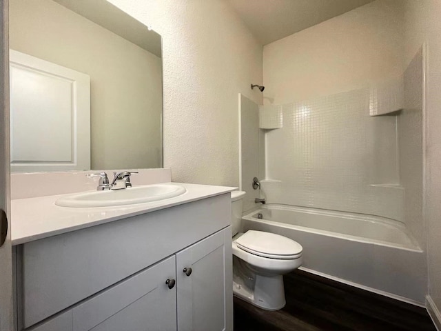 full bath featuring vanity, toilet, wood finished floors, and bathtub / shower combination