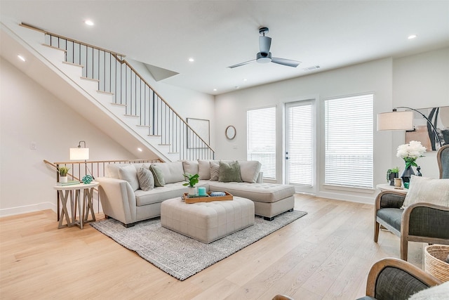 living area with visible vents, baseboards, recessed lighting, stairs, and light wood-type flooring