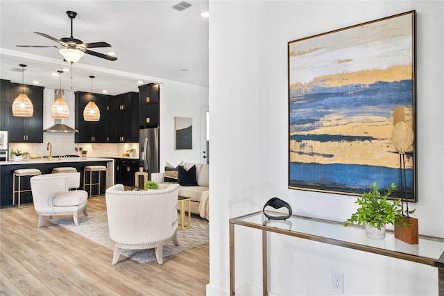 living area featuring light wood finished floors, visible vents, recessed lighting, and a ceiling fan