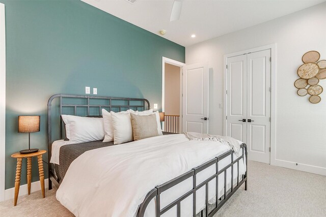 bedroom featuring a ceiling fan, baseboards, recessed lighting, a closet, and light colored carpet