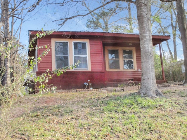 view of side of home featuring brick siding