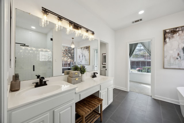 full bath featuring a sink, visible vents, double vanity, and a shower stall