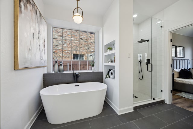 bathroom with tile patterned flooring, baseboards, a stall shower, and a freestanding bath