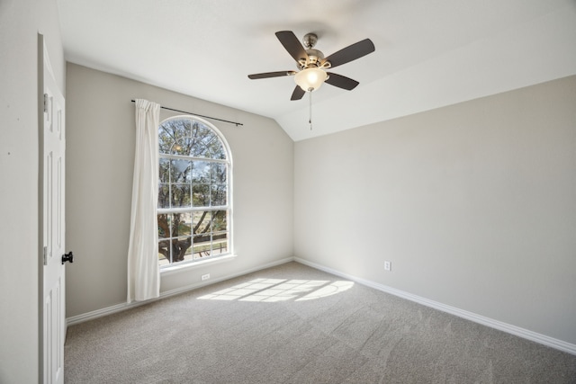 unfurnished room with baseboards, a ceiling fan, lofted ceiling, and carpet floors