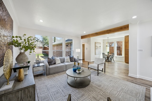 living room featuring beam ceiling, recessed lighting, baseboards, and wood finished floors