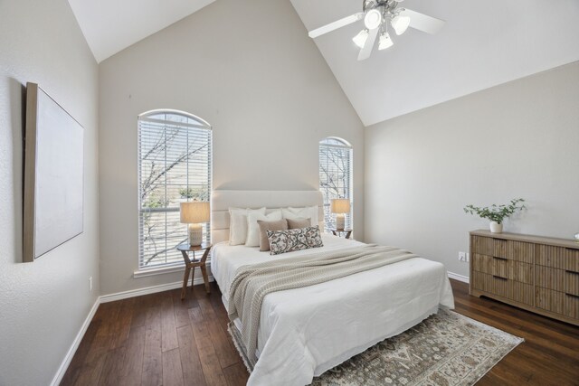 bedroom featuring multiple windows, baseboards, and wood finished floors